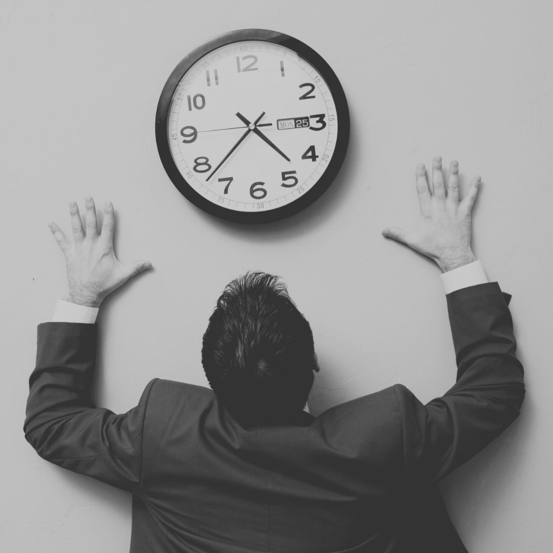 worker looking at clock, managing time not work